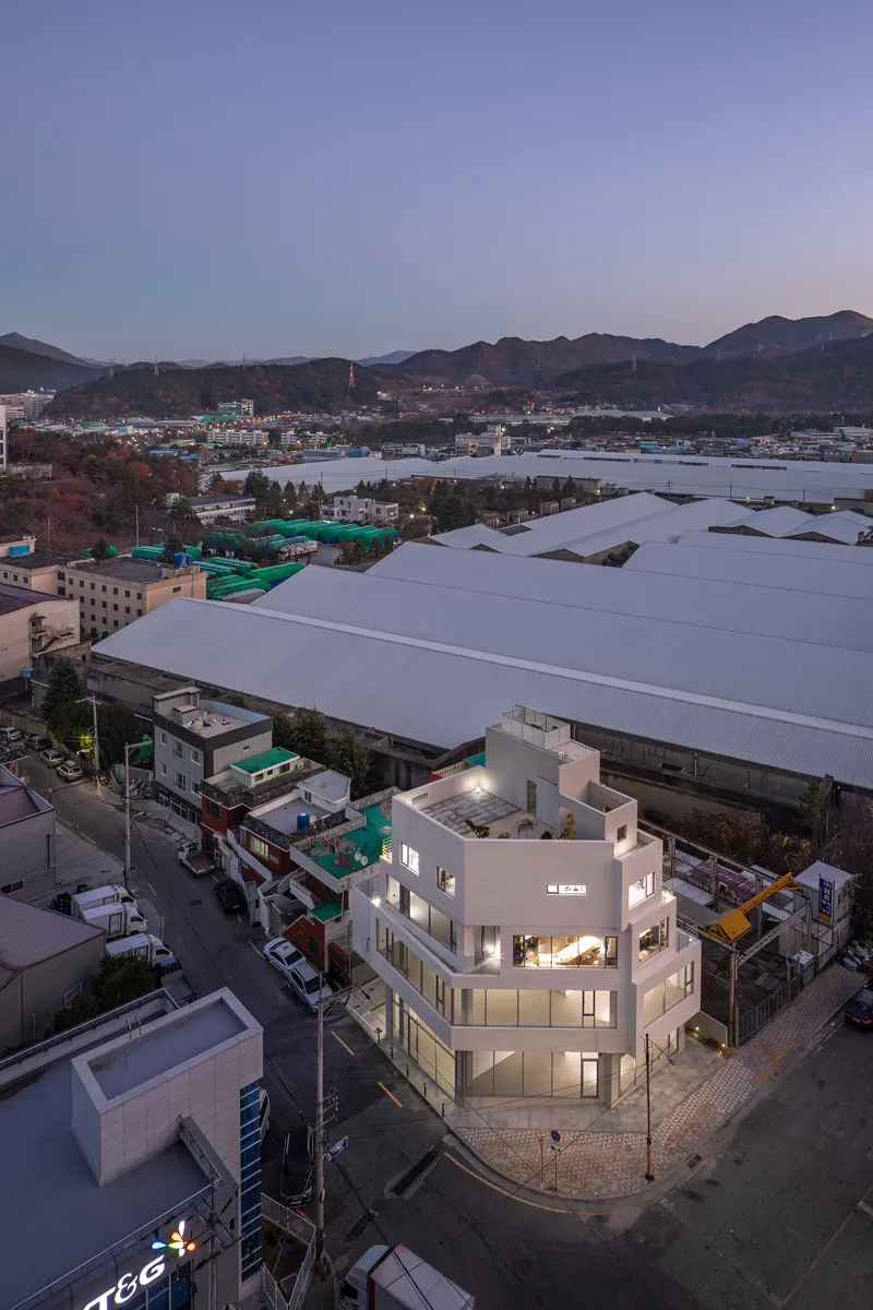 Aerial view of the corner building at dusk with mountains in the distance