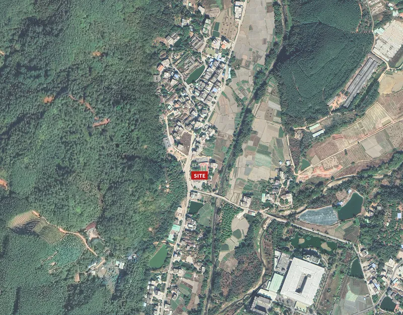 Aerial site map showing the location within a rural village surrounded by fields and forest