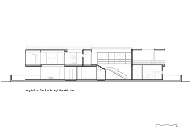 Longitudinal section drawing through the staircase showing split-level interior volumes and roof heights