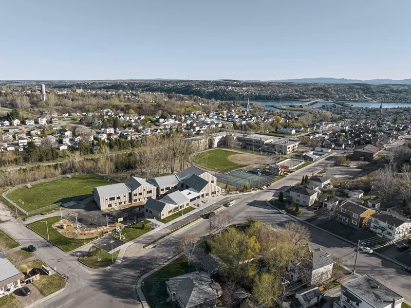 Aerial view of the cluster of residential buildings arranged around a green courtyard in a suburban neighborhood