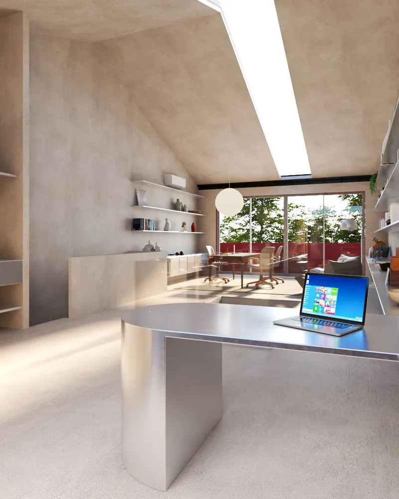 Workspace with angled skylight above desk looking toward window and red exterior wall beyond