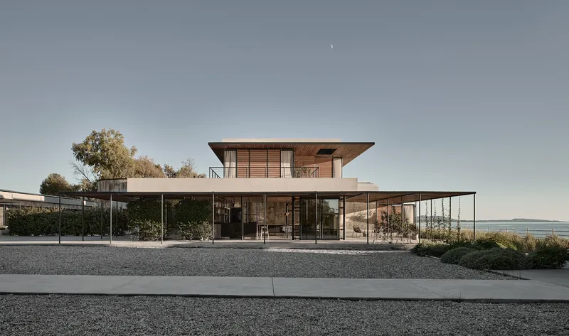 Pavilion with cantilevered timber roof and steel-framed perimeter canopy overlooking the waterfront