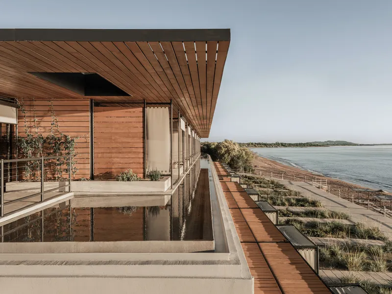 Rooftop terrace with reflecting pool and timber deck overlooking coastal wetlands