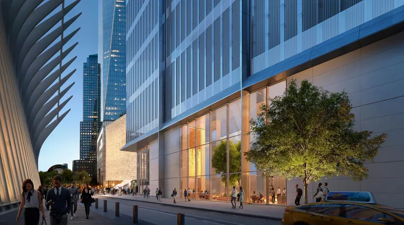 Ground-floor lobby entrance with planted trees and pedestrians beneath the vertical glass facade