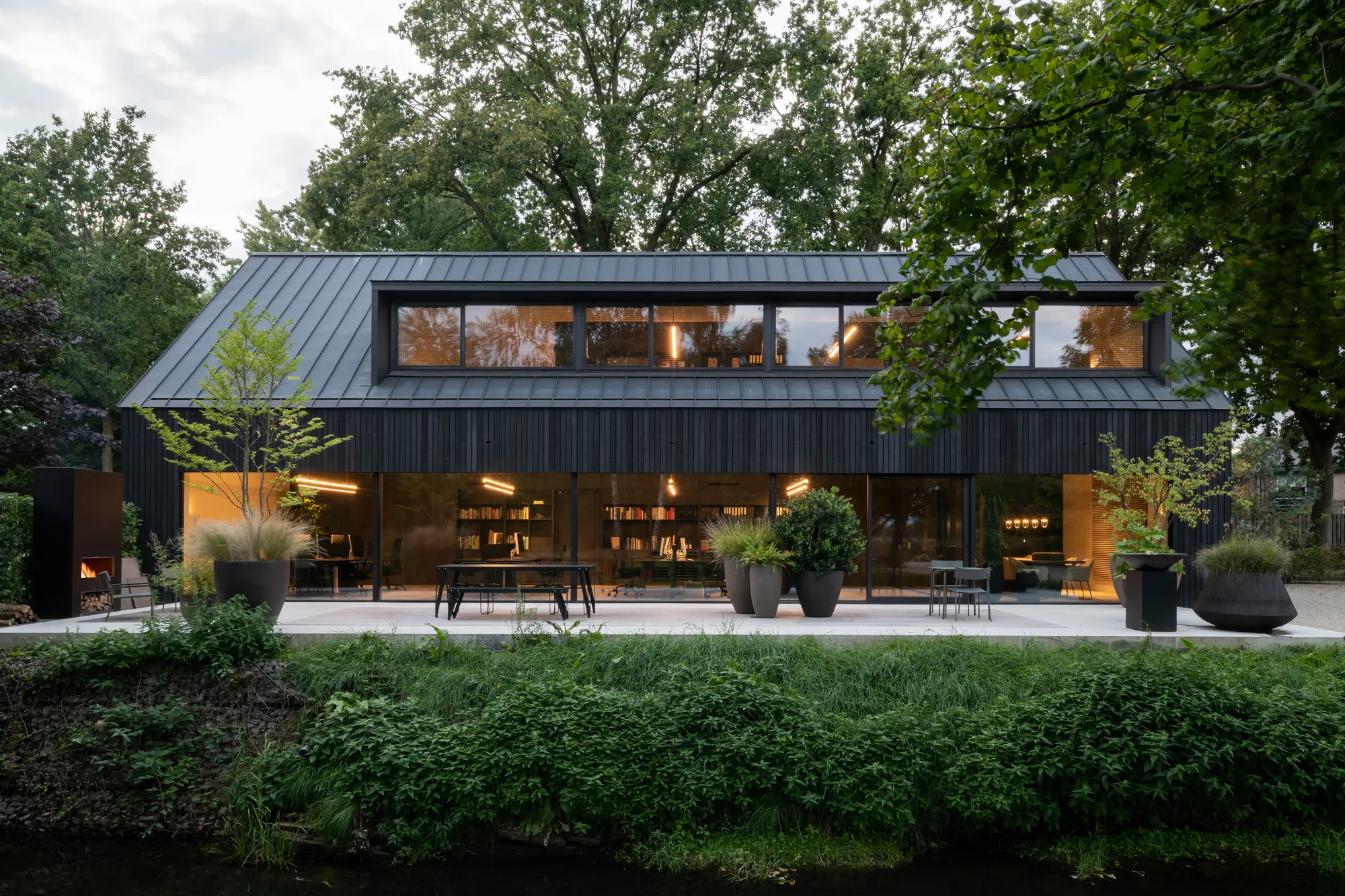 studio] [Space Builds a Black Barn Office That Disappears Behind the Dutch Landscape
