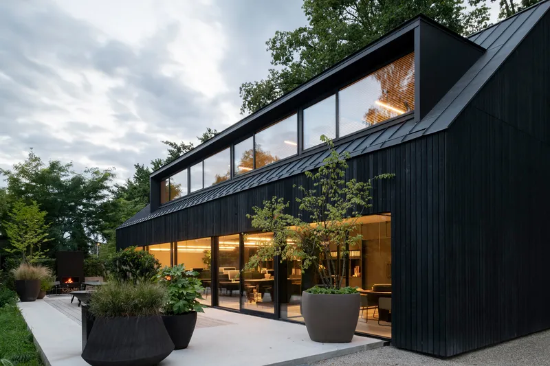 Angled view of the vertical timber facade and clerestory glazing above the terrace planters