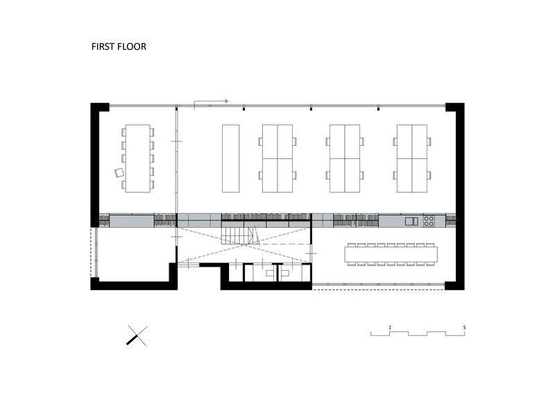 First floor plan showing workspace areas, central stair void, and terrace extension