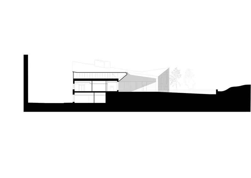 Section drawing revealing tiered interior levels embedded into sloping terrain with trees visible above