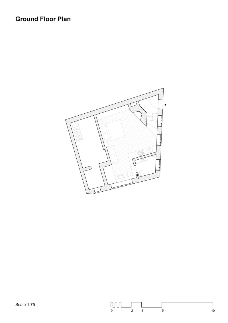 Ground floor plan drawing showing an irregular trapezoidal volume with two enclosed rooms