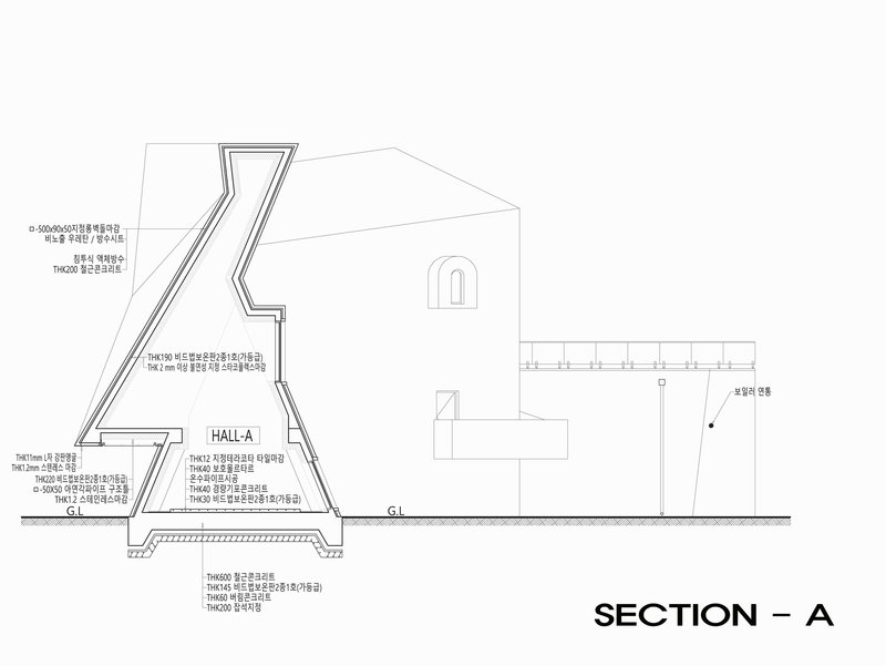 Section drawing revealing the sloped interior hall beneath an angular skylight with material callouts