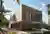 YH2 Architecture Stacks Two Wooden Blocks on a Rocky Outcrop Above Lake Memphremagog