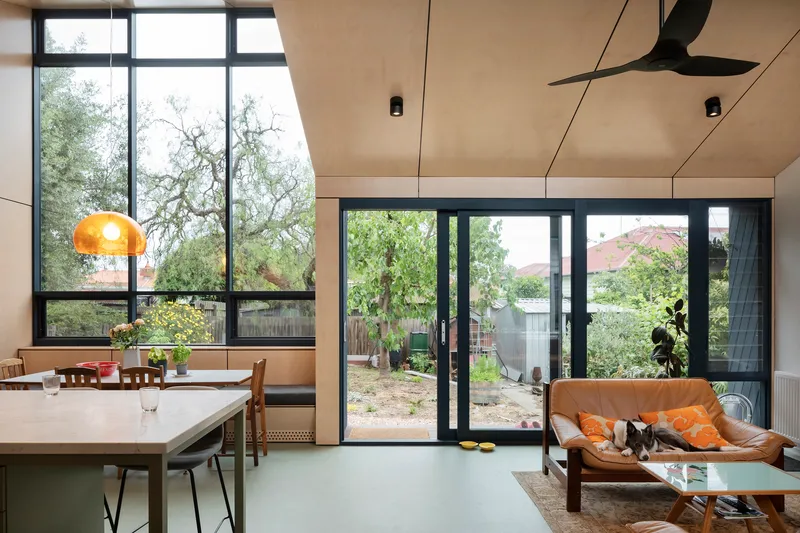 This architectural photo showcases a modern interior with a seamless blend of indoor and outdoor spaces. The design features large windows and sliding doors tha