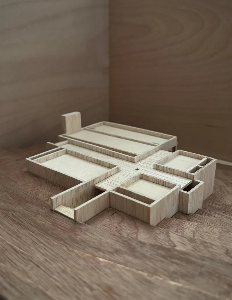 Oblique view of the layered wood study model showing terraced volumes in shadow