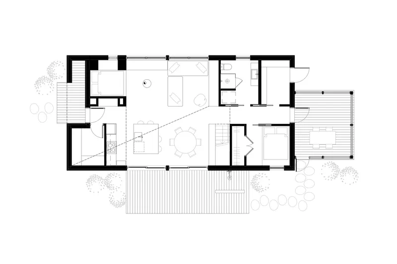 Floor plan showing open living and dining areas with exterior decks and surrounding vegetation