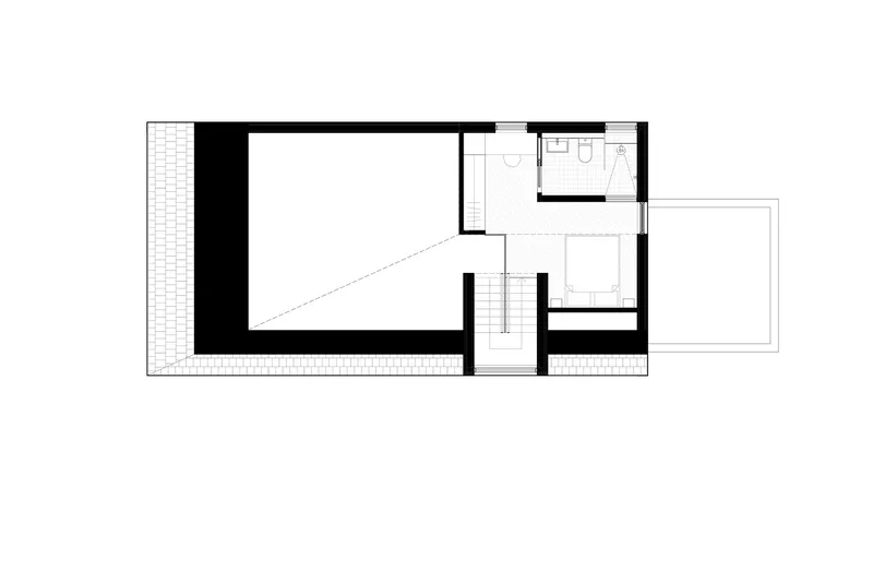 Upper level floor plan with central stairwell connecting a large open space and bathroom