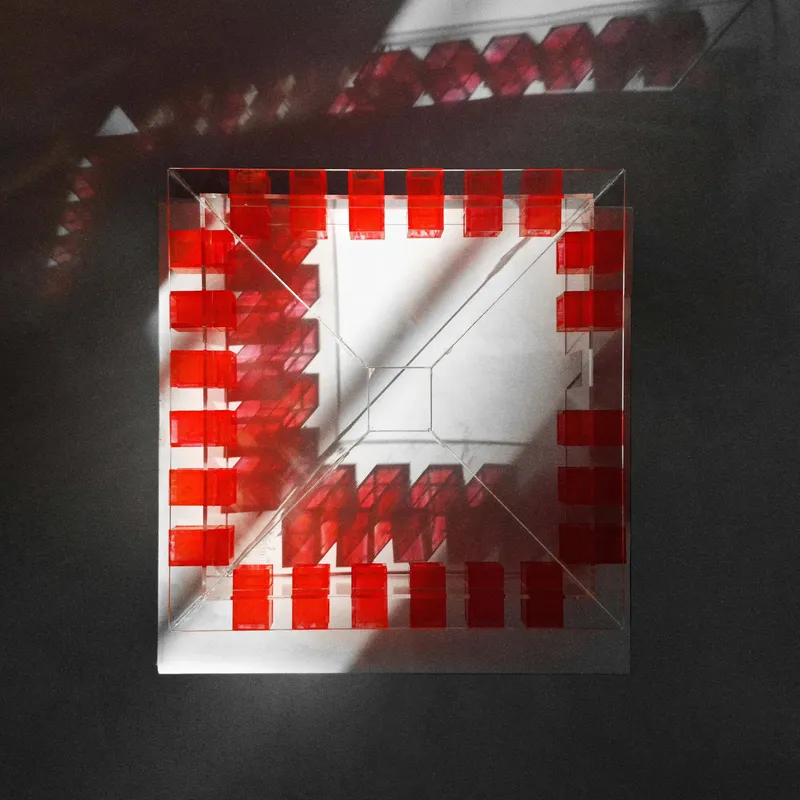Top-down view of the model revealing the square courtyard surrounded by red programmatic blocks