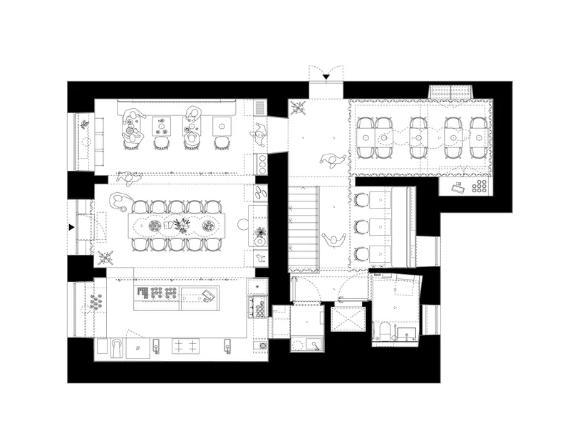 Floor plan drawing showing open dining and meeting spaces with a central staircase and perimeter service rooms