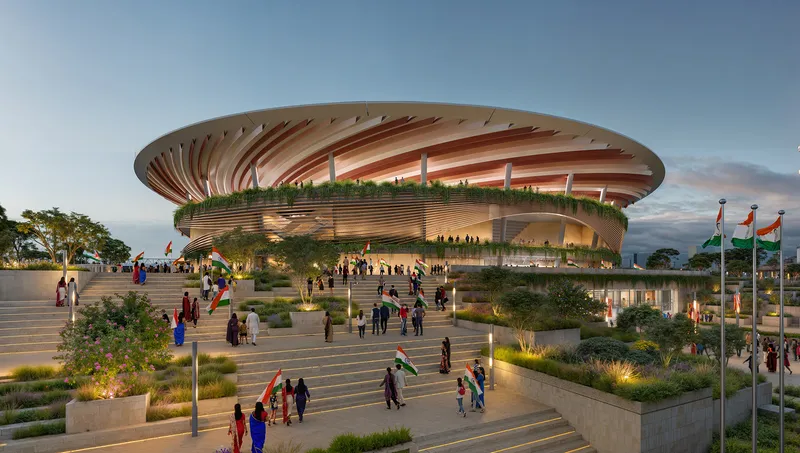 Oval stadium with radiating roof canopy and horizontal timber louvers over terraced plaza with planted beds