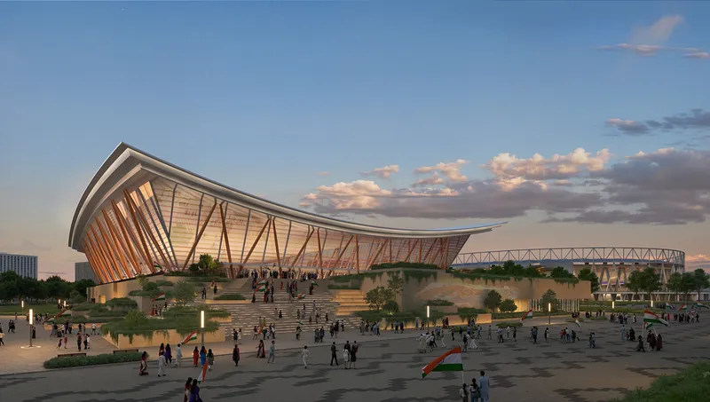 Arena with angled facade fins and sweeping roof canopy at sunset with approaching pedestrians and footbridge