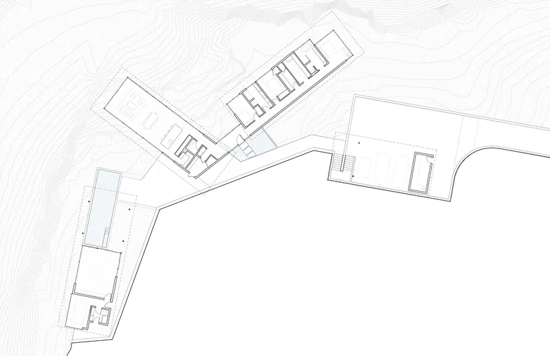Site plan drawing showing angled building volumes following contour lines on sloped terrain