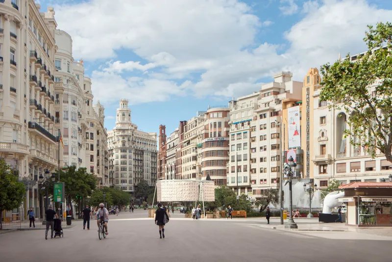 Temporary pavilion structure positioned in a public square surrounded by historic apartment buildings