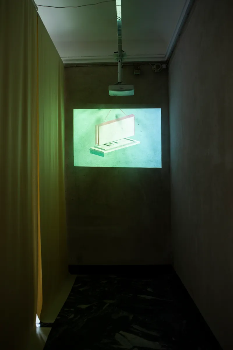 Narrow corridor with projected image of open sample case illuminated by green light