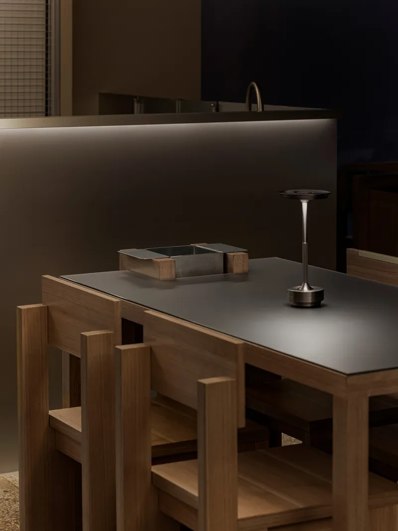 Close-up of oak dining table with matte grey surface and geometric timber base