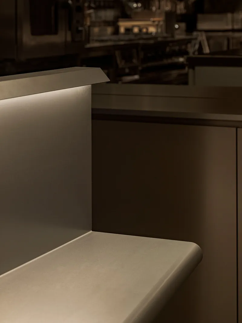 Detail of upholstered banquette seating with recessed LED strip lighting at the edge