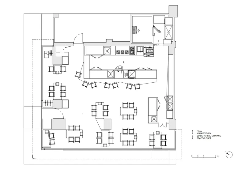 Floor plan showing an open dining area with scattered table groupings and a galley kitchen along one wall