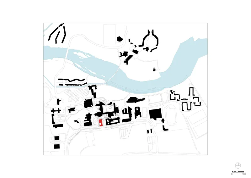 Site plan drawing showing building footprints in black along a curving waterway in blue