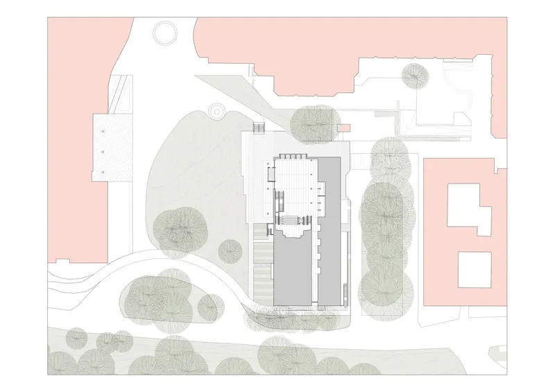 Site plan with central building footprint surrounded by tree canopies rendered in grey and pink