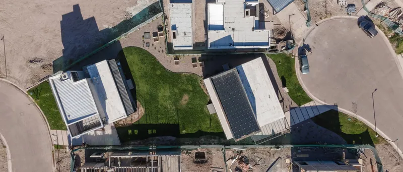 Aerial view of the two-story volume and its rear yard within the surrounding residential neighborhood