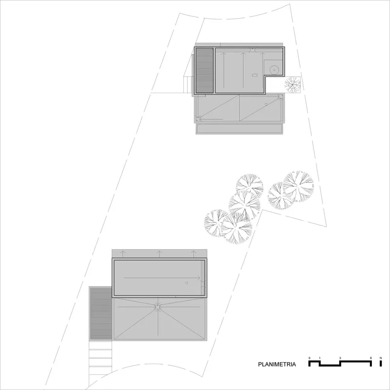 Site plan drawing showing two residential volumes on an irregular lot with tree plantings between