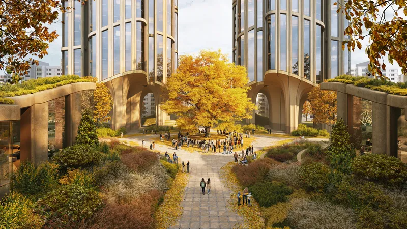 Elevated courtyard with paved walkways and autumn trees between paired arched canopies at tower bases