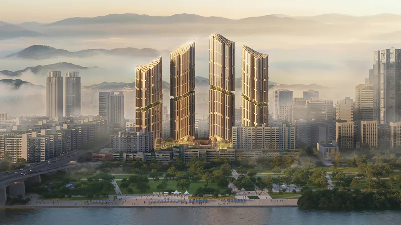 Five ribbed residential towers rising above a waterfront promenade at dawn with misty mountains beyond