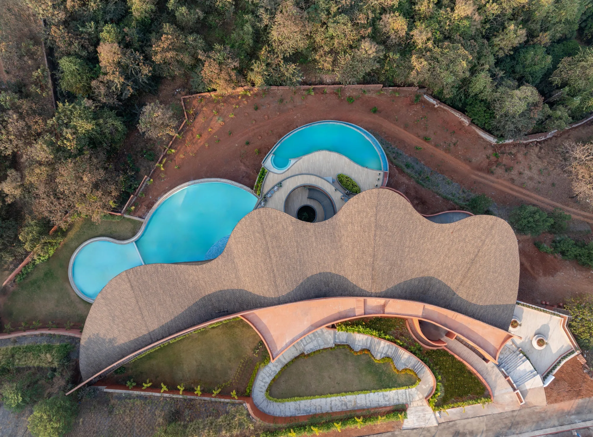 Sanjay Puri Architects Cascades a Laterite Community Center Down a Hillside Over the Arabian Sea