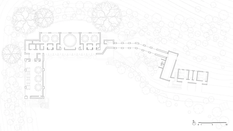 Floor plan drawing showing interior layout with circular stair and terraced passage connecting two wings