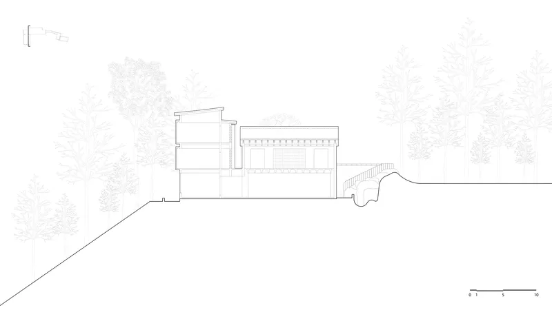 Section drawing revealing a two-story volume with clerestory windows set into a sloping hillside with trees