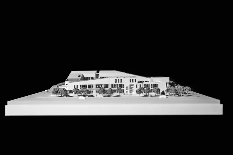 Physical model showing the massing with repetitive facade openings and landscaped perimeter trees