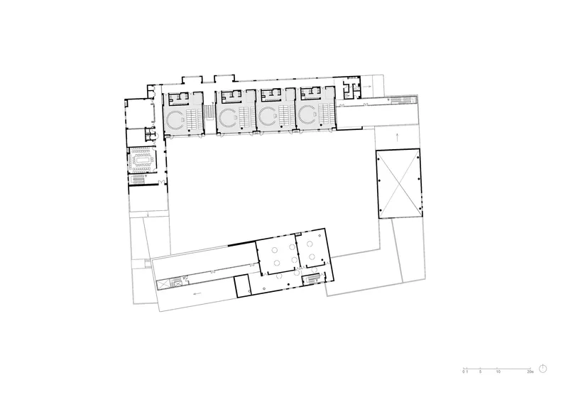 Upper floor plan drawing revealing four classrooms with curved interior features along the northern wing