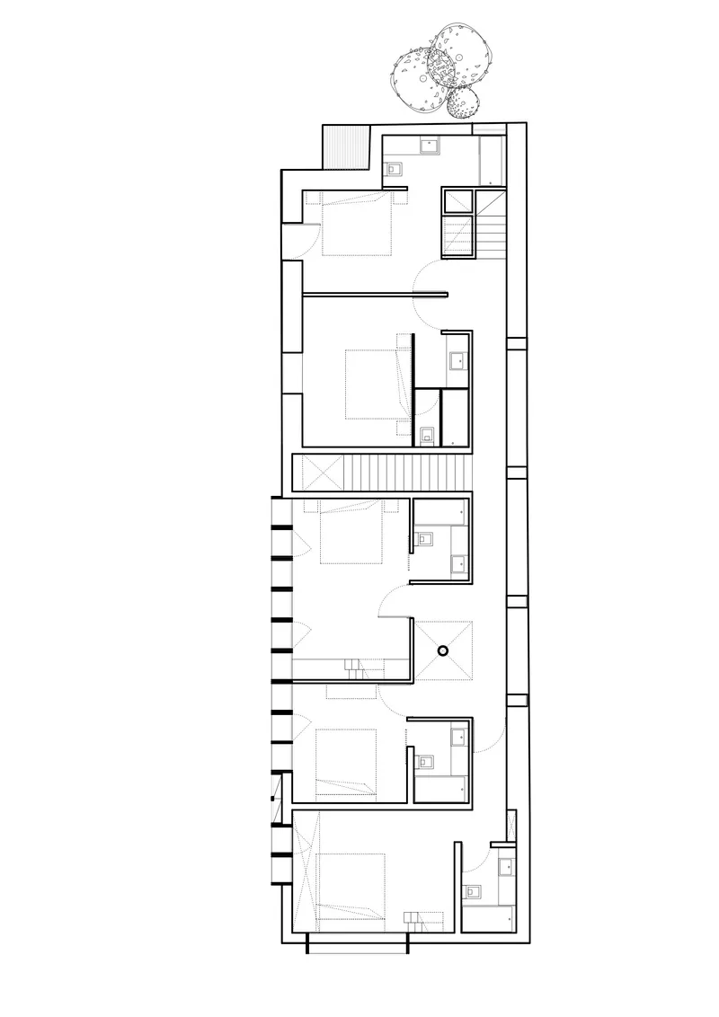 First floor plan drawing showing bedroom layout with bathrooms and central staircase