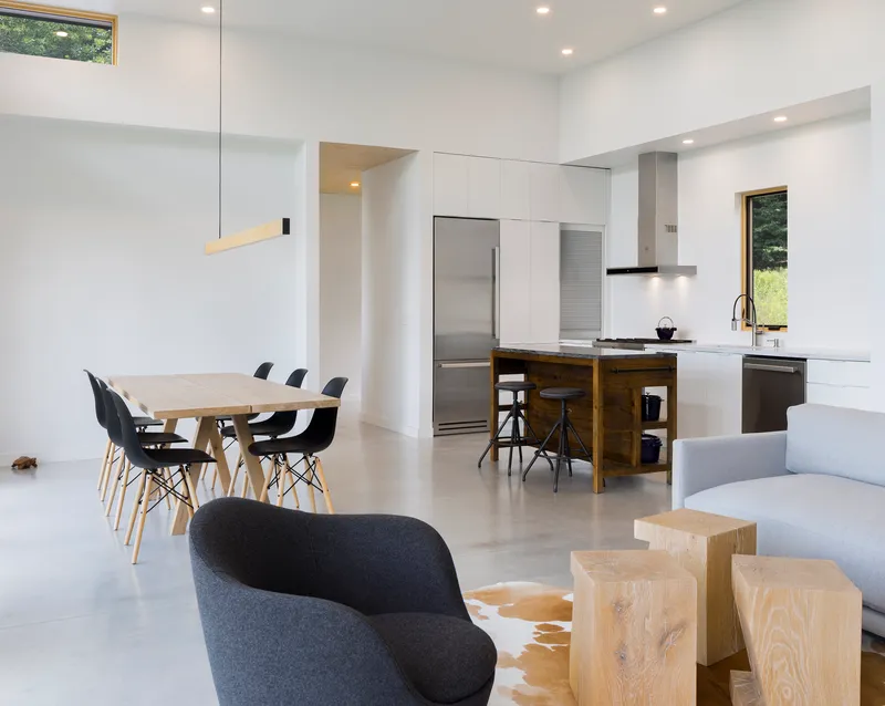 Open plan kitchen and dining area with polished concrete floor and clerestory windows