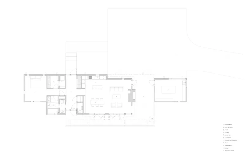 Floor plan drawing showing a linear arrangement of rooms with a central living area and detached garage