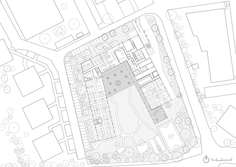 Ground floor plan drawing depicting building perimeter with interior rooms arranged around central courtyard space