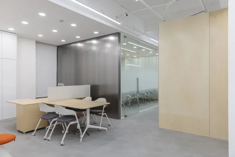 Reception desk with polished concrete floor and glass-walled conference room beyond