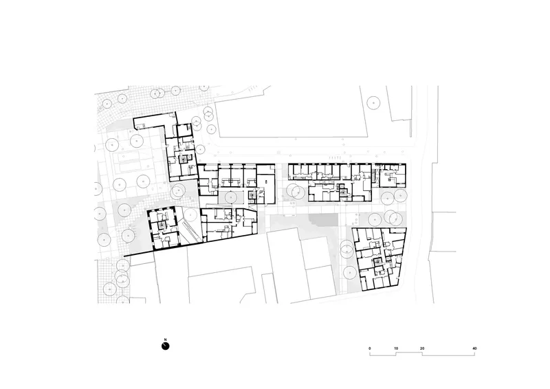 Ground floor plan drawing depicting multiple building blocks arranged around courtyards and landscaped areas