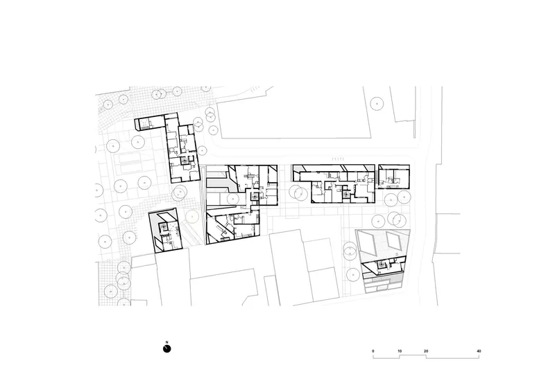 Upper floor plan drawing showing residential units distributed across connected building volumes