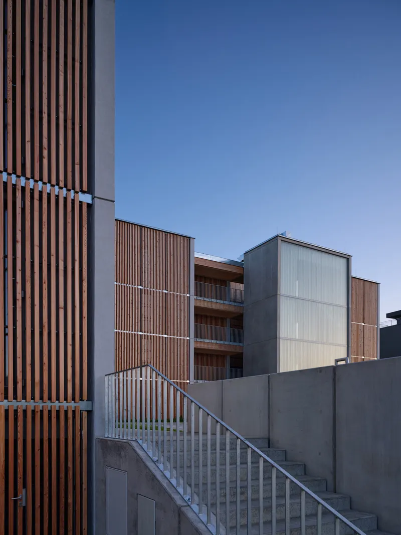 View of the vertical timber louvered facade with external stair leading to the upper residential levels