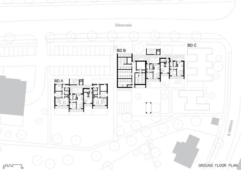 Ground floor plan showing three residential blocks with surrounding landscaped areas and circular trees