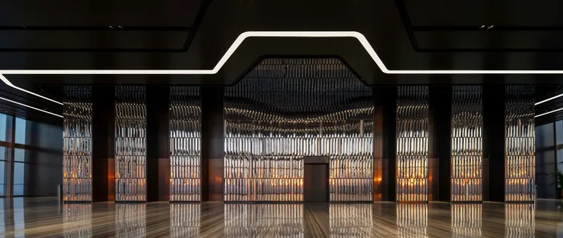 Symmetrical view of backlit metal screen panels between dark columns under geometric ceiling cutout